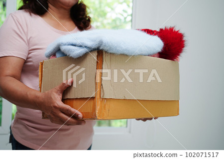 Clothes donations in cardboard box for volunteer. Clothes donations in cardboard box for volunteer. 102071517