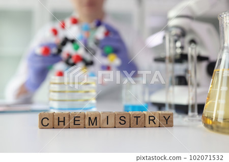 Word Chemistry made of cubes near laboratory glassware 102071532