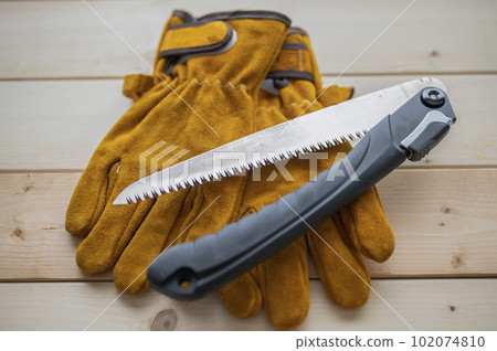 Essential items for camping Leather gloves and a folding saw 102074810