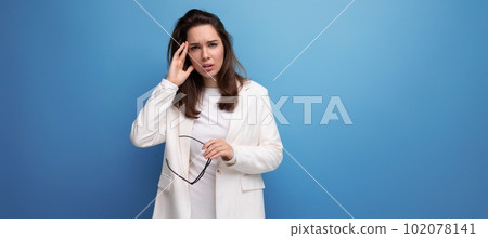 portrait of a young lady in a white dress and glasses with a headache portrait of a young lady in a white dress and glasses with a headache 102078141