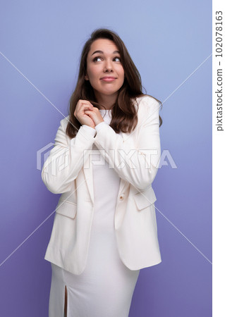 portrait of a well-groomed caucasian brunette woman in a white dress 102078163