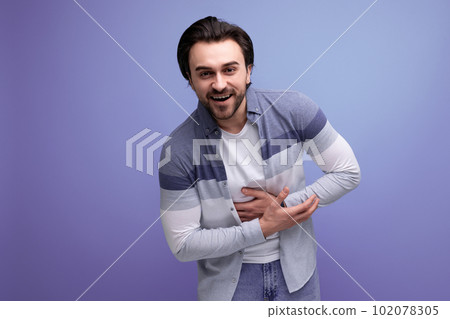 young brunette man in sweater posing on studio background young brunette man in sweater posing on studio background 102078305