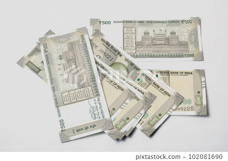 500 hundred rupees Indian money isolated on white background. Pile of Indian money five hundred rupee currency banknotes. 500 hundred rupees Indian money isolated on white background. Pile of Indian money five hundred rupee currency banknotes. 102081690