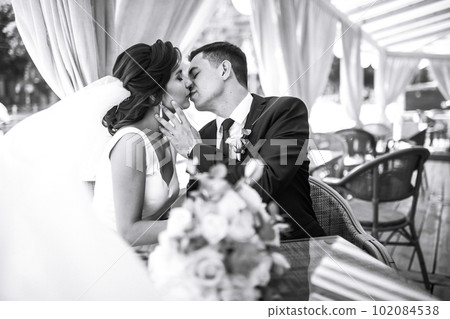Black and white photo of cheerful emotional newlyweds who enjoy each other. Romantic moment. Together. 102084538