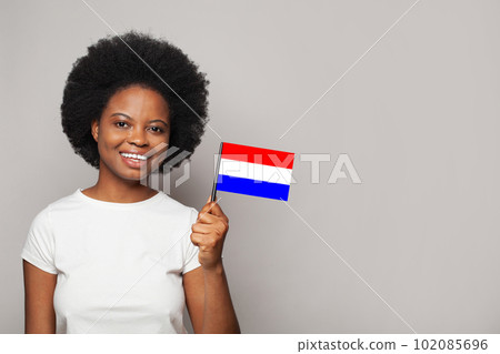 Netherlands woman holding flag of Netherlands. Education, business, citizenship 102085696