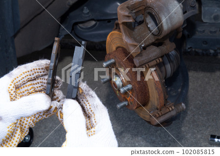 Car brake pad replacement work New and old brake pads 102085815