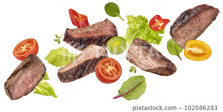 Flying steak salad isolated on white background 102086283