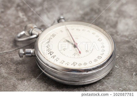 Old stopwatch on a gray background 102087781