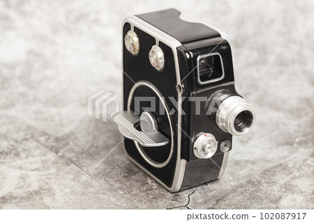 Vintage movie camera isolated on white Vintage movie camera isolated on white 102087917