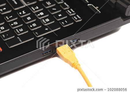 laptop with USB orange cable. 102088056