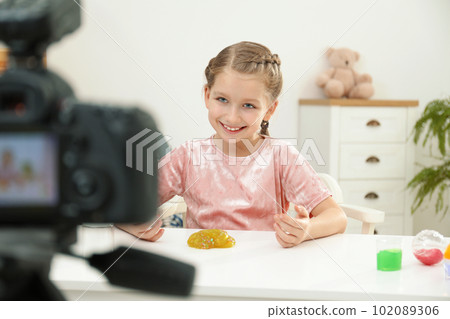 Cute little blogger with slime recording video at home 102089306