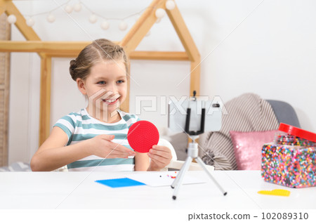 Cute little blogger with handcrafting recording video at home Cute little blogger with handcrafting recording video at home 102089310