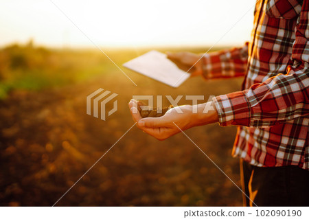 Hand of expert farmer collect soil and checking soil health before growth a seed of vegetable. Hand of expert farmer collect soil and checking soil health before growth a seed of vegetable. 102090190