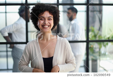 business woman with her staff in background at office business woman with her staff in background at office 102090549
