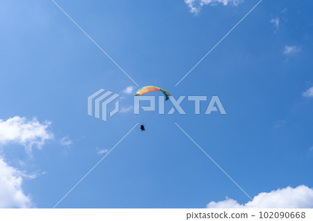 Paragliding dancing in the blue sky Paragliding dancing in the blue sky 102090668