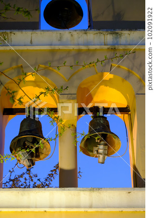 Greek orthodox church bells lit at night in a church in Preveza in Greece Greek orthodox church bells lit at night in a church in Preveza in Greece 102091922