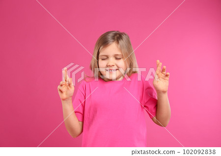Cute little girl with crossed fingers on pink background Cute little girl with crossed fingers on pink background 102092838