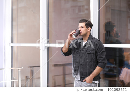 Handsome man drinking coffee near window. Space for text Handsome man drinking coffee near window. Space for text 102092851