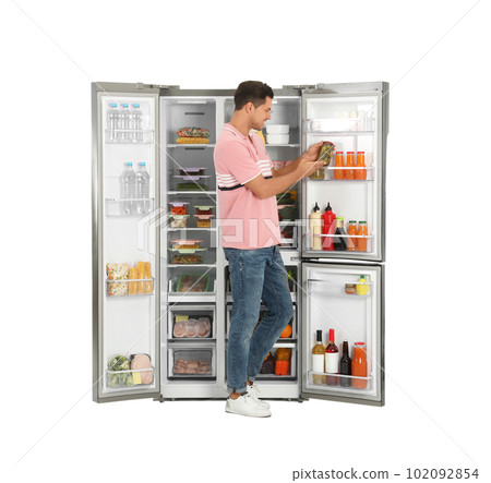 Man taking pickles from refrigerator on white background Man taking pickles from refrigerator on white background 102092854