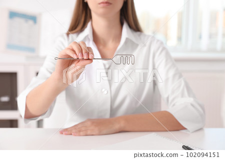 Speech therapist with logopedic probe in clinic, closeup Speech therapist with logopedic probe in clinic, closeup 102094151