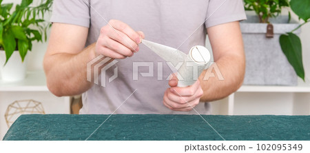 A man changes the sticky layer to a new one to A man changes the sticky layer to a new one to 102095349