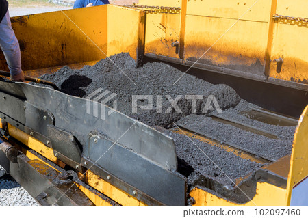 When laying new asphalt roads in layering process an asphalt paver machine steam road roller are being used in construction roads 102097460