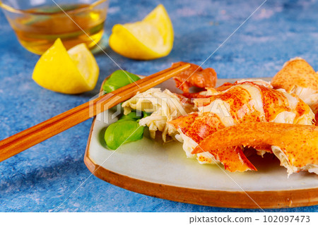 Delicious seafood meal of fresh lobster is cooked to perfection in gourmet dinner kitchen before it served with lemon 102097473