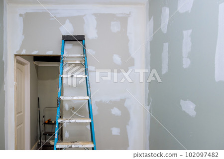 In this newly built house that has been plastered with drywall is now ready for painting In this newly built house that has been plastered with drywall is now ready for painting 102097482