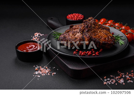 Delicious beef or pork steak on the bone grilled with spices and rosemary 102097506