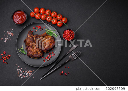Delicious beef or pork steak on the bone grilled with spices and rosemary Delicious beef or pork steak on the bone grilled with spices and rosemary 102097509