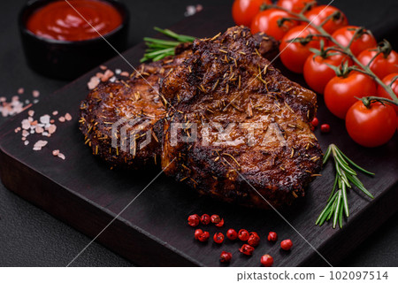 Delicious beef or pork steak on the bone grilled with spices and rosemary 102097514