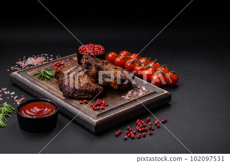 Delicious beef or pork steak on the bone grilled with spices and rosemary Delicious beef or pork steak on the bone grilled with spices and rosemary 102097531