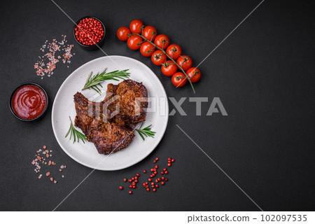 Delicious beef or pork steak on the bone grilled with spices and rosemary Delicious beef or pork steak on the bone grilled with spices and rosemary 102097535