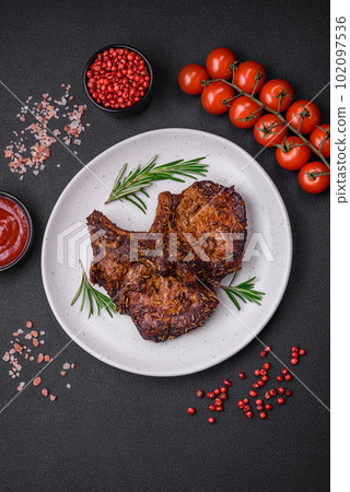 Delicious beef or pork steak on the bone grilled with spices and rosemary Delicious beef or pork steak on the bone grilled with spices and rosemary 102097536