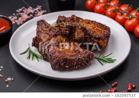 Delicious beef or pork steak on the bone grilled with spices and rosemary Delicious beef or pork steak on the bone grilled with spices and rosemary 102097537