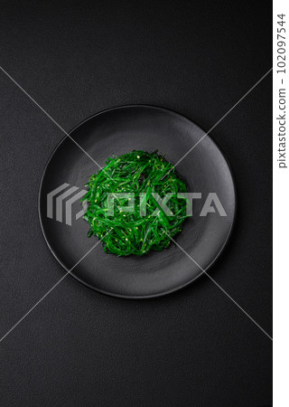 Delicious healthy vegetarian hiashi wakume seafood salad with sesame seeds 102097544