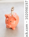 Piggy bank with polish paper money on concrete table - business or financial concept in vertical banner 102098197