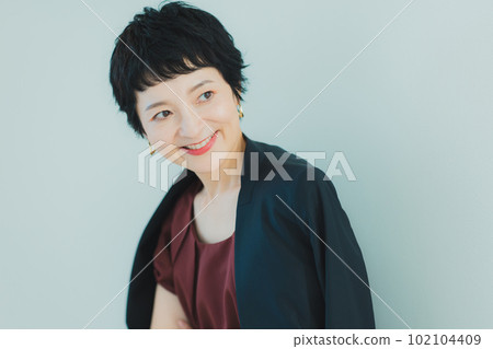 Middle-aged woman with very short hair Middle-aged woman with very short hair 102104409