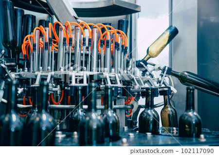 Conveyor belt bottle washing machine in drink factory. Automatic wine bottle washer, Rotary glass bottle washing machine. Conveyor belt bottle washing machine in drink factory. Automatic wine bottle washer, Rotary glass bottle washing machine. 102117090