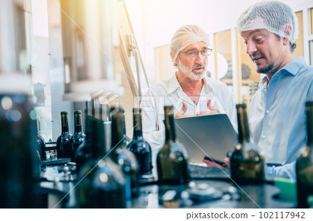 Food production process inspector team working in beverage bottle conveyor line Food production process inspector team working in beverage bottle conveyor line 102117942