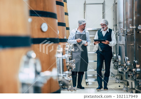Winemaker working in modern large winery factory liquor drink industry quality and fermentation monitor 102117949