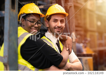 Happy industry worker friends working together mix race gender. black woman with hispanic latin man. 102118149