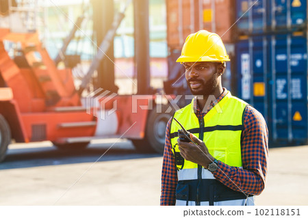 Logistic worker black male working in port cargo container yard operate  manage loading control 102118151