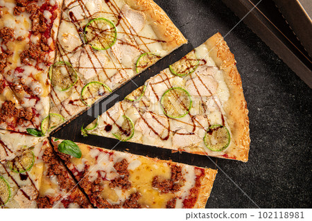 Big assorted pizza with variety of toppings 102118981