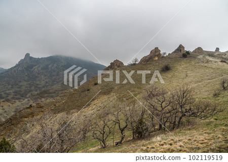 Landscape of Karadag Reserve in spring. View of rocks of ridge Karagach. Crimea Landscape of Karadag Reserve in spring. View of rocks of ridge Karagach. Crimea 102119519