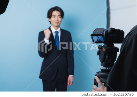 A young man in a suit 102120786