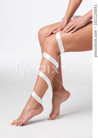 Woman with ribbon on leg Woman with ribbon on leg 102120891