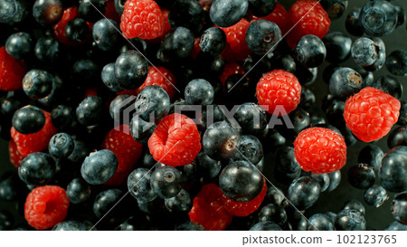 Falling berries, isolated on black background 102123765