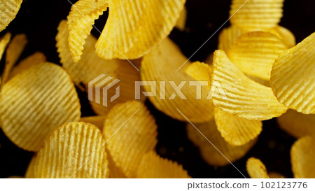 Potatoes chips flying up in the air. 102123776