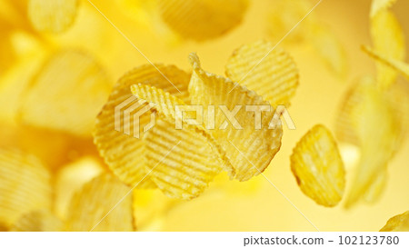 Potatoes chips flying up in the air. Potatoes chips flying up in the air. 102123780